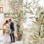 Un couple s'embrassant sous une arche florale élégante, symbolisant un mariage romantique organisé par By Mademoiselle C, wedding planner en Provence, Côte d'Azur & Corse. Cette scène de grand cérémonial se déroule dans un domaine privé, entouré de verdure et d'une ambiance sophistiquée, parfaite pour une célébration unique. Les détails sur mesure et l'atmosphère intime créent un cadre idéal pour un rêve de mariage, où chaque élément est